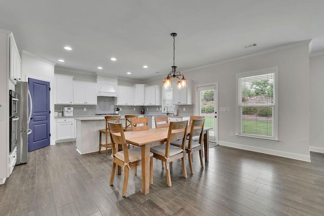 7190 Tributary Ct, Cumming, GA 30040 - dining area with crown molding, dark wood-type flooring, baseboards, and recessed lighting