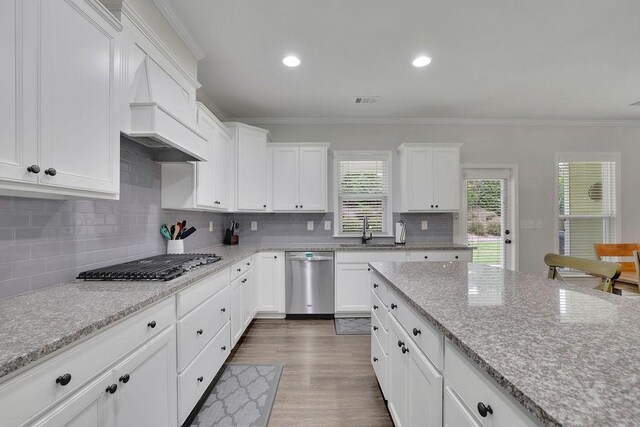 7190 Tributary Ct, Cumming, GA 30040 - kitchen featuring appliances with stainless steel finishes, crown molding, white cabinets, tasteful backsplash, and dark wood-style floors