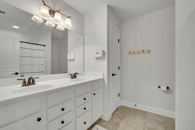 7190 Tributary Ct, Cumming, GA 30040 - bathroom featuring double vanity and baseboards