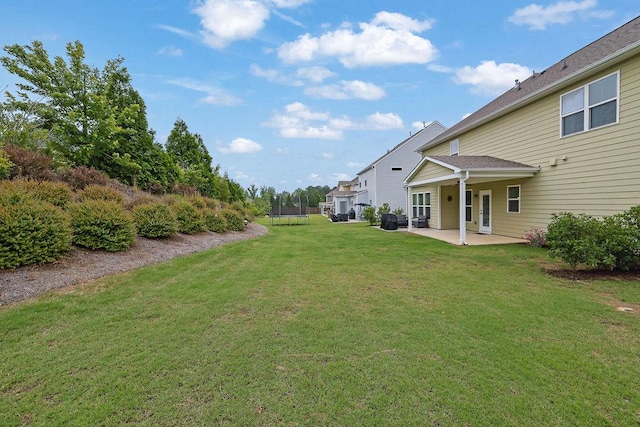 7190 Tributary Ct, Cumming, GA 30040 - view of green lawn featuring a trampoline and a patio area