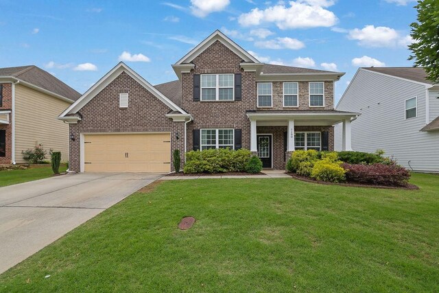 7190 Tributary Ct, Cumming, GA 30040 - view of front of home featuring brick siding, a front lawn, concrete driveway, and an attached garage