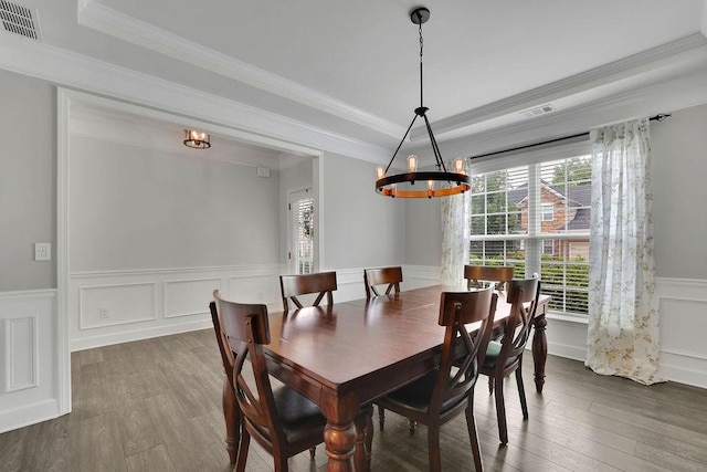 7190 Tributary Ct, Cumming, GA 30040 - dining space featuring a chandelier, ornamental molding, wood finished floors, a wainscoted wall, and a decorative wall