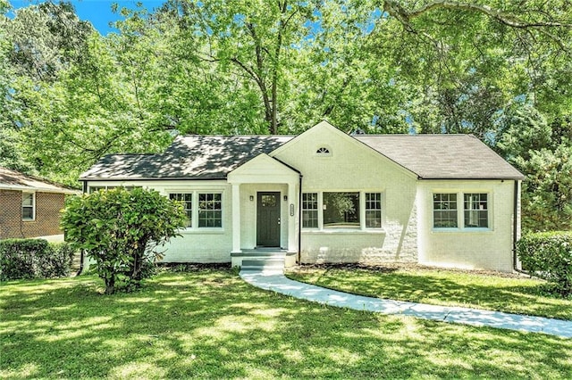 ranch-style home with a front lawn