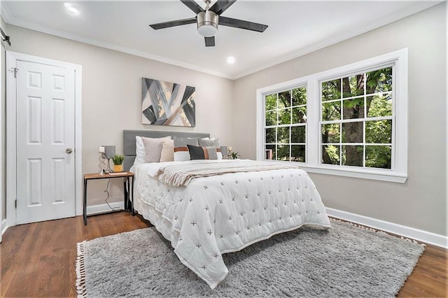 bedroom with ceiling fan, crown molding, and dark hardwood / wood-style floors