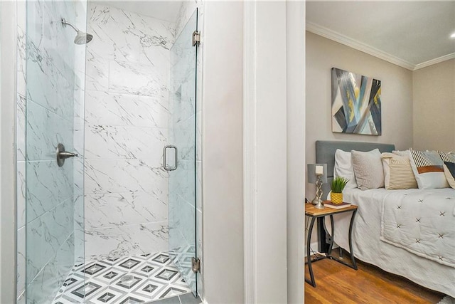 bathroom featuring ornamental molding, hardwood / wood-style floors, and a shower with door