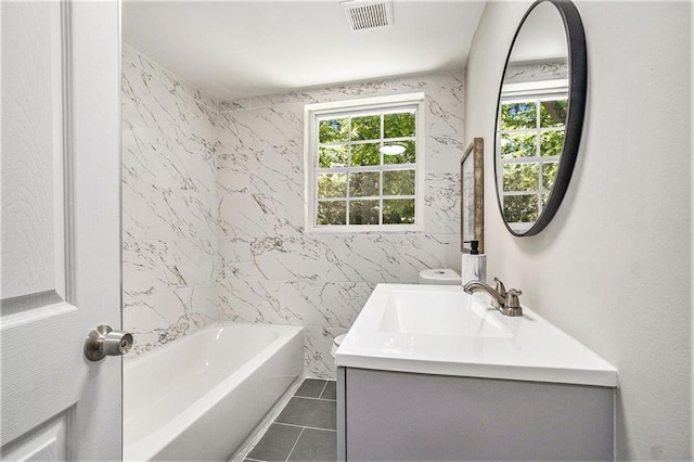 bathroom with vanity, tile patterned flooring, and shower / bathtub combination