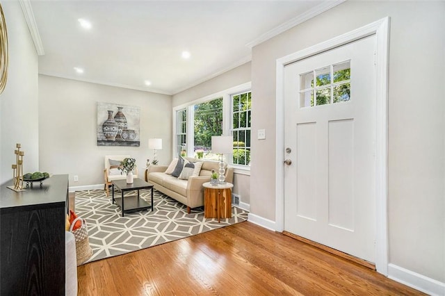 entryway with wood-type flooring and ornamental molding