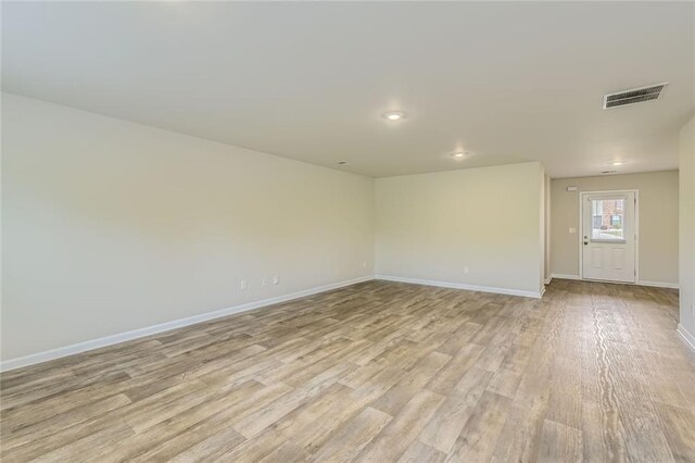 unfurnished room with recessed lighting, baseboards, visible vents, and light wood-style flooring