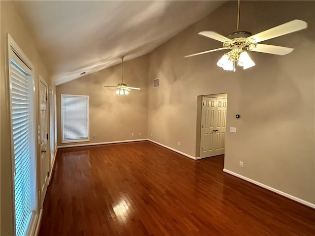 spare room with ceiling fan, dark hardwood / wood-style floors, and vaulted ceiling