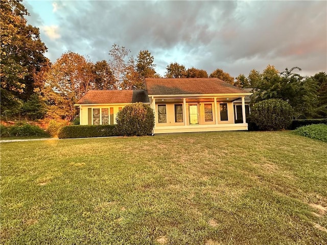 rear view of house with a lawn