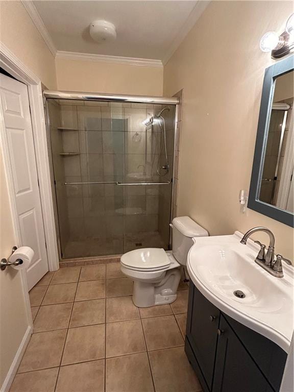 bathroom with vanity, tile patterned flooring, toilet, ornamental molding, and a shower with shower door