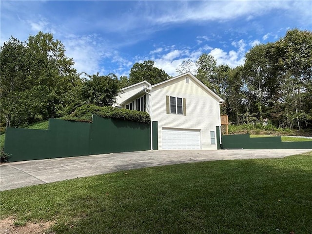 view of side of property with a garage and a yard