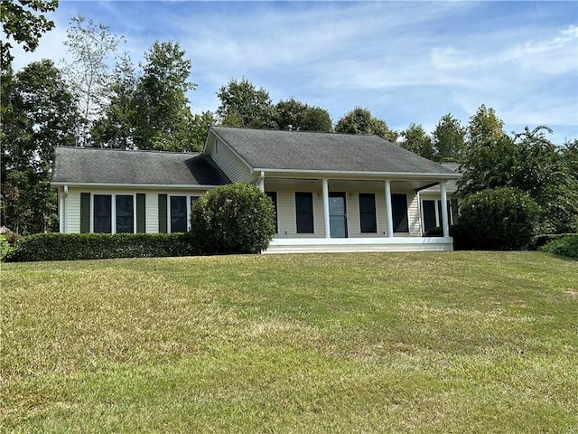 view of front of home with covered porch and a front lawn