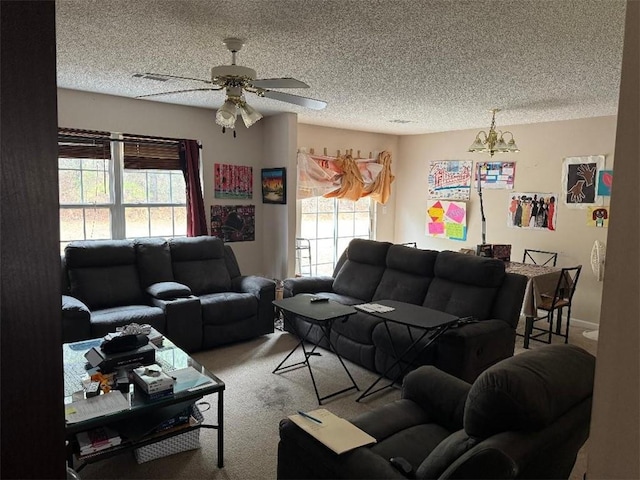 carpeted living room featuring ceiling fan and a textured ceiling