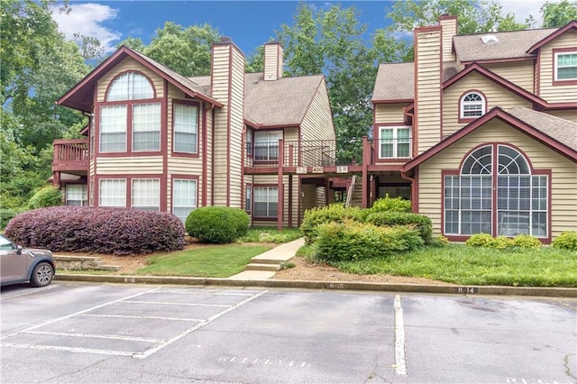 404 Hawkstone Way, Alpharetta, GA 30022 - view of front of home featuring uncovered parking and a chimney