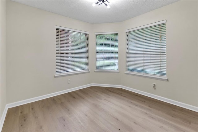 404 Hawkstone Way, Alpharetta, GA 30022 - unfurnished room with wood finished floors and a textured ceiling