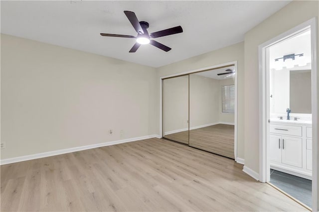 404 Hawkstone Way, Alpharetta, GA 30022 - unfurnished bedroom with light wood-style flooring, a closet, ensuite bath, and a ceiling fan