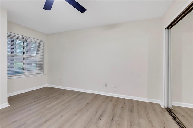 404 Hawkstone Way, Alpharetta, GA 30022 - unfurnished bedroom featuring wood finished floors, a ceiling fan, and a closet