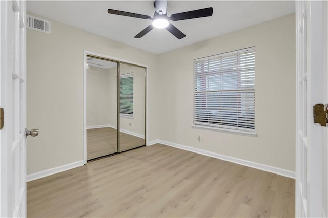 404 Hawkstone Way, Alpharetta, GA 30022 - unfurnished bedroom with light wood-style flooring, a closet, and ceiling fan