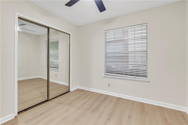 404 Hawkstone Way, Alpharetta, GA 30022 - unfurnished bedroom featuring wood finished floors, a closet, and a ceiling fan