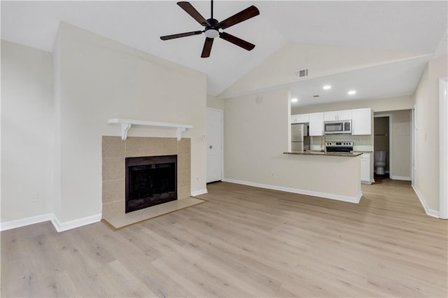 404 Hawkstone Way, Alpharetta, GA 30022 - unfurnished living room featuring a ceiling fan, light wood-style floors, a tiled fireplace, recessed lighting, and high vaulted ceiling