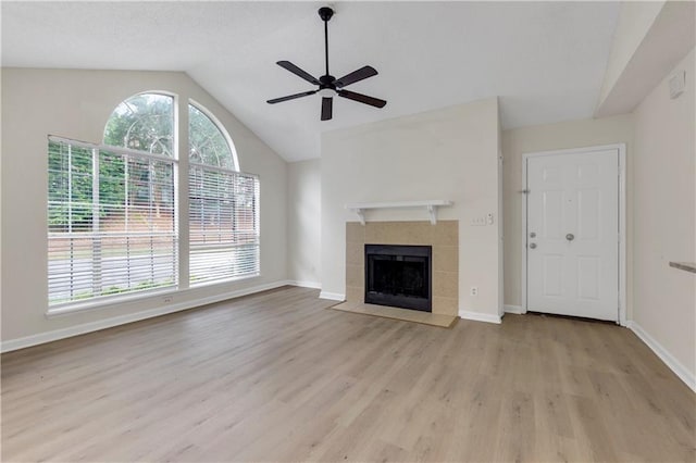 404 Hawkstone Way, Alpharetta, GA 30022 - unfurnished living room featuring wood finished floors, vaulted ceiling, a ceiling fan, and a tiled fireplace