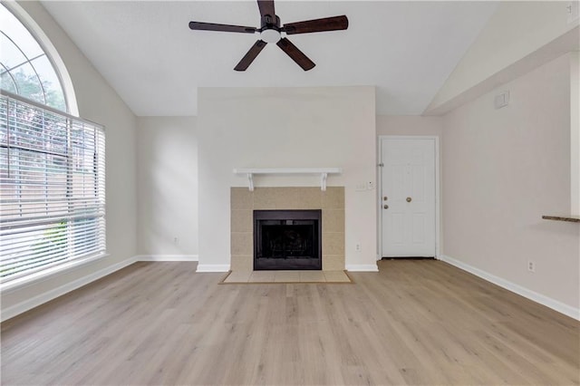 404 Hawkstone Way, Alpharetta, GA 30022 - unfurnished living room featuring vaulted ceiling, ceiling fan, wood finished floors, and a tile fireplace
