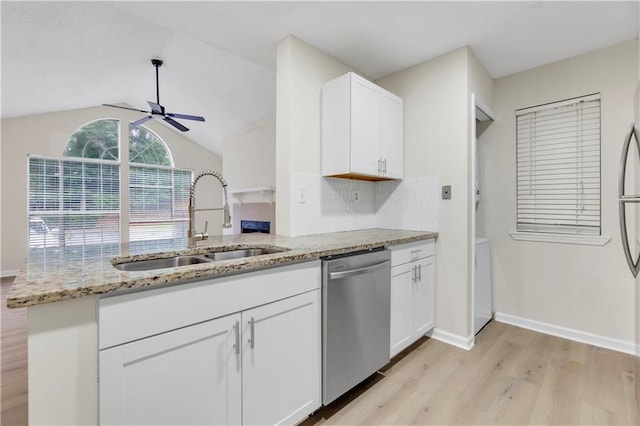 404 Hawkstone Way, Alpharetta, GA 30022 - kitchen with stainless steel dishwasher, light wood-style floors, ceiling fan, light stone countertops, and white cabinets