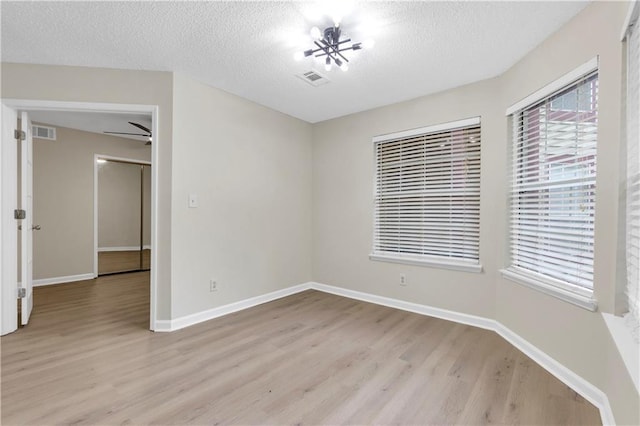 404 Hawkstone Way, Alpharetta, GA 30022 - unfurnished room with light wood-type flooring and a textured ceiling