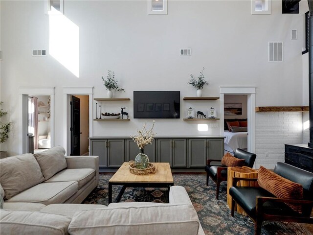 living area with a towering ceiling and visible vents