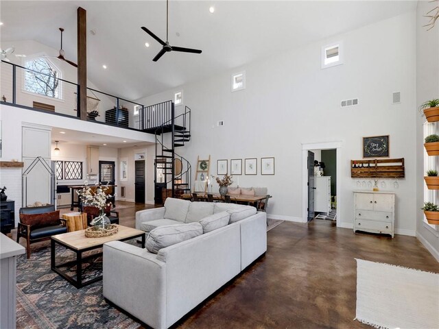 living room with ceiling fan, stairway, visible vents, and baseboards