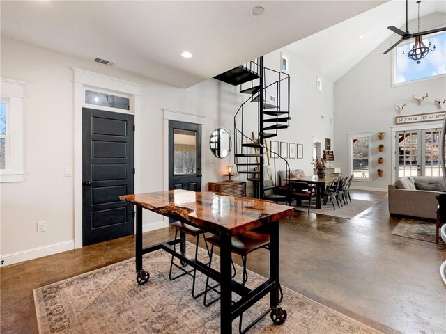 dining space featuring stairway, baseboards, and finished concrete flooring