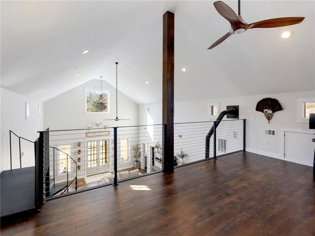 additional living space featuring baseboards, visible vents, lofted ceiling, ceiling fan, and wood finished floors