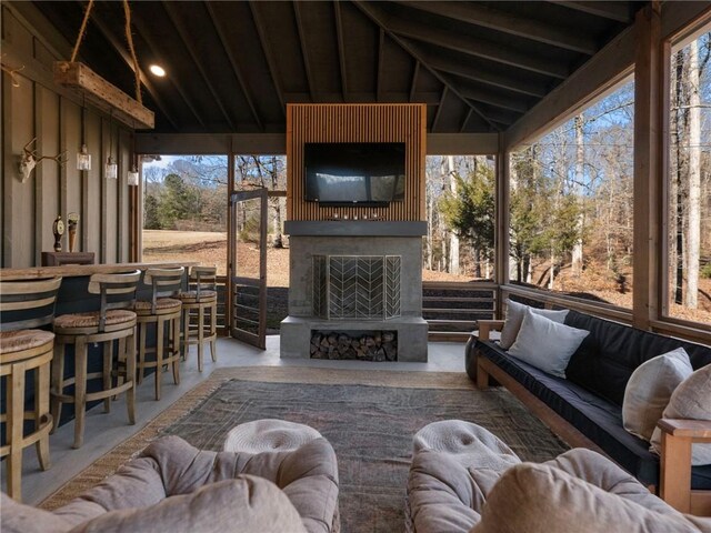 sunroom featuring vaulted ceiling