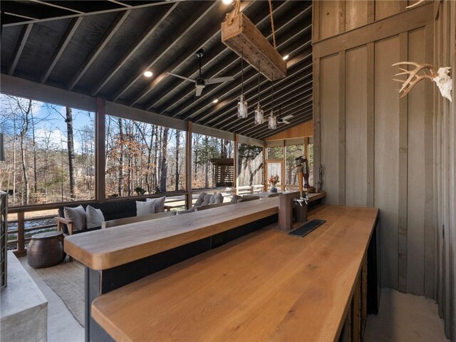 interior space featuring a ceiling fan and lofted ceiling