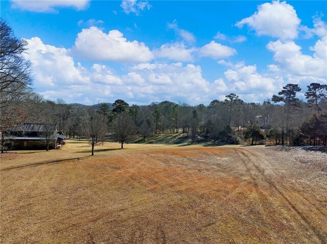 exterior space featuring a rural view and a wooded view