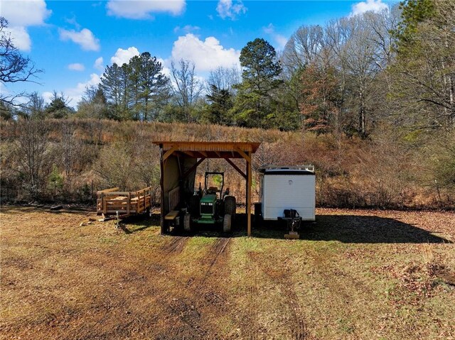 view of outdoor structure featuring a detached carport and an outbuilding