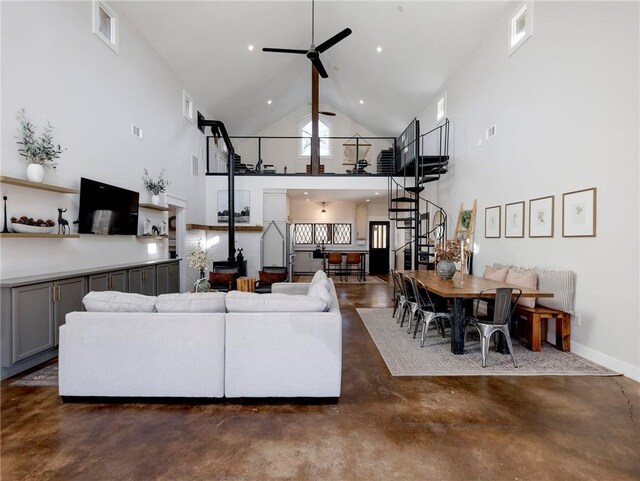 living room with visible vents, a high ceiling, finished concrete floors, a ceiling fan, and stairs