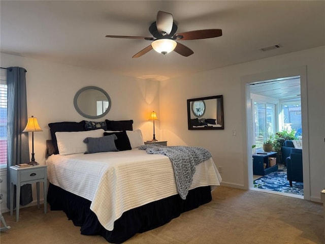 bedroom featuring ceiling fan, access to exterior, and light carpet