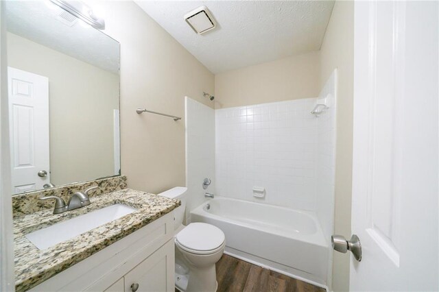 1129 Winston Dr, Decatur, GA 30032 - full bathroom featuring hardwood / wood-style floors, a textured ceiling, bathing tub / shower combination, vanity, and toilet