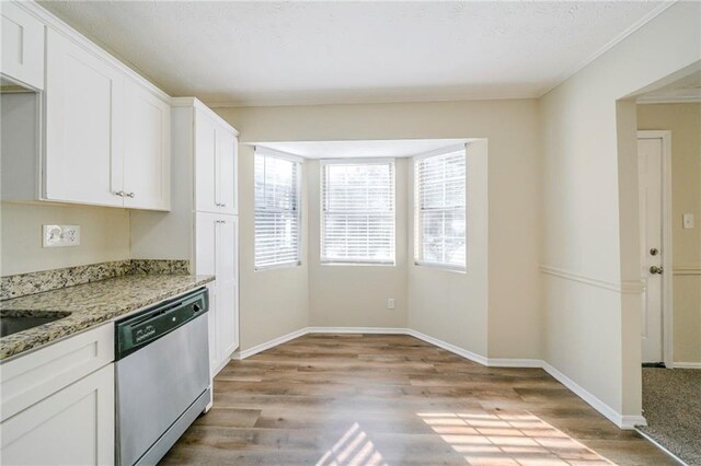 1129 Winston Dr, Decatur, GA 30032 - kitchen featuring light stone countertops, white cabinetry, dishwasher, and light hardwood / wood-style flooring