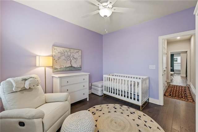 bedroom featuring ceiling fan, dark wood-type flooring, and baseboards