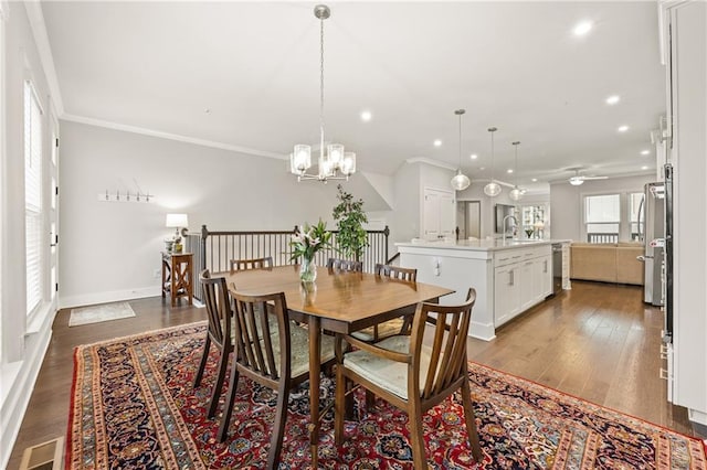 dining room featuring recessed lighting, wood finished floors, visible vents, baseboards, and crown molding