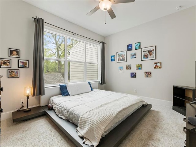 bedroom featuring ceiling fan and carpet