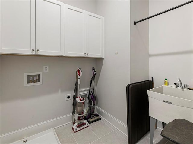 clothes washing area featuring washer hookup, cabinets, light tile patterned flooring, and hookup for an electric dryer