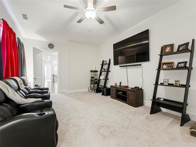 carpeted living room with ceiling fan