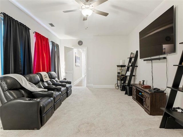 cinema with ceiling fan and light colored carpet