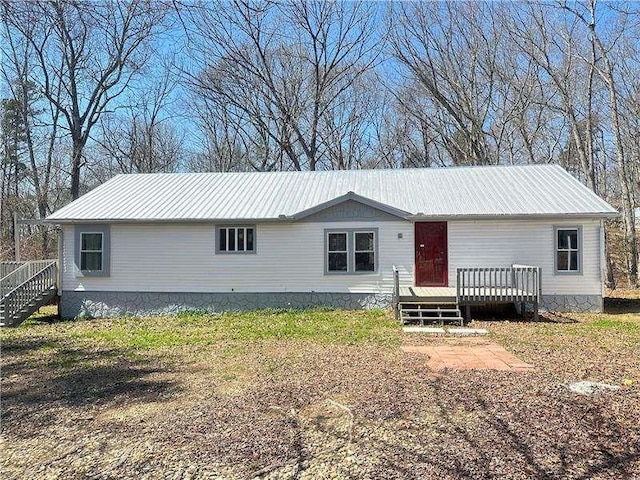 manufactured / mobile home featuring a wooden deck and metal roof