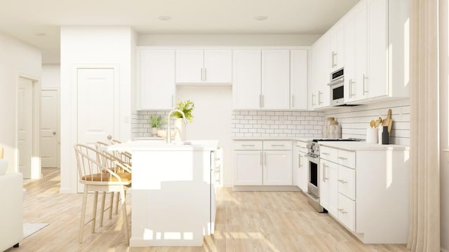2447 Livi Ln, Buford, GA 30519 - kitchen with decorative backsplash, stainless steel range, light wood-style floors, and a kitchen island with sink