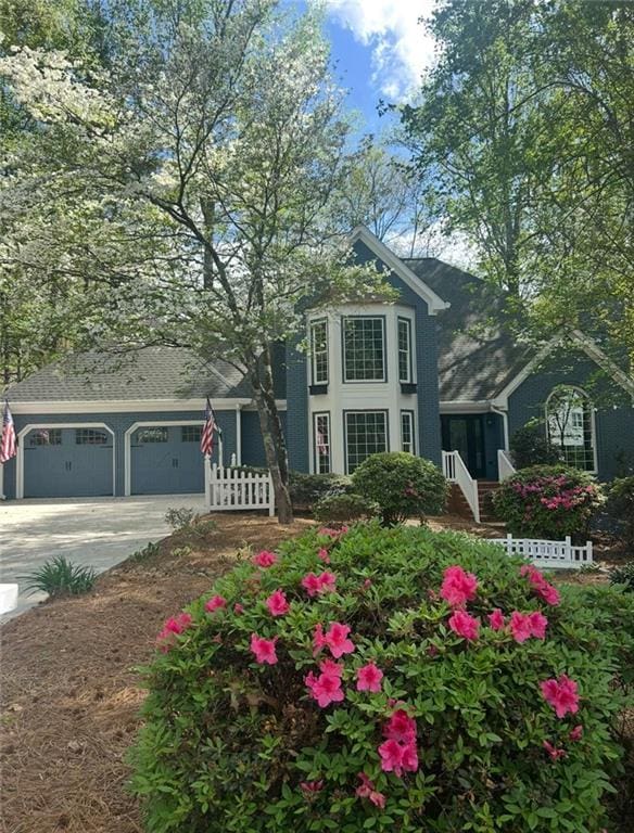 3017 Lana Ln, Marietta, GA 30066 - view of front of home with concrete driveway, a garage, and fence